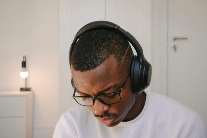 a man wearing headphones and reading a book, inspired by Theo Constanté, hurufiyya, black rimmed glasses, profile image, mkbhd, finely textured