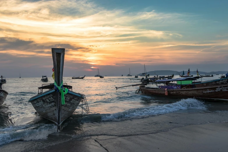 a group of boats sitting on top of a beach, pexels contest winner, thawan duchanee, sunset colors, grey, boat with lamp