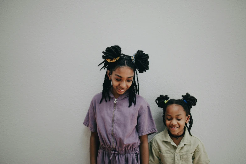 a couple of kids standing next to each other, by Nina Hamnett, pexels contest winner, afrofuturism, with black pigtails, bedhead, violet and black, justina blakeney