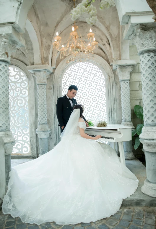 a man in a tuxedo standing next to a woman in a wedding dress, pexels contest winner, romanticism, grand piano, white stone arches, indonesia, wearing organza gown
