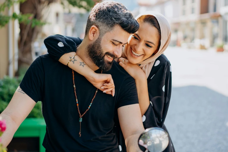 a man riding on the back of a woman on a motorcycle, a picture, pexels contest winner, hurufiyya, smiling couple, middle eastern skin, holding close, stylized