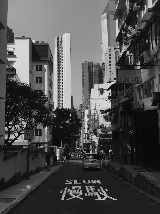 a black and white photo of a city street, by Adam Rex, cinematic. by leng jun, victoria siemer, jisu choe, tourist photo