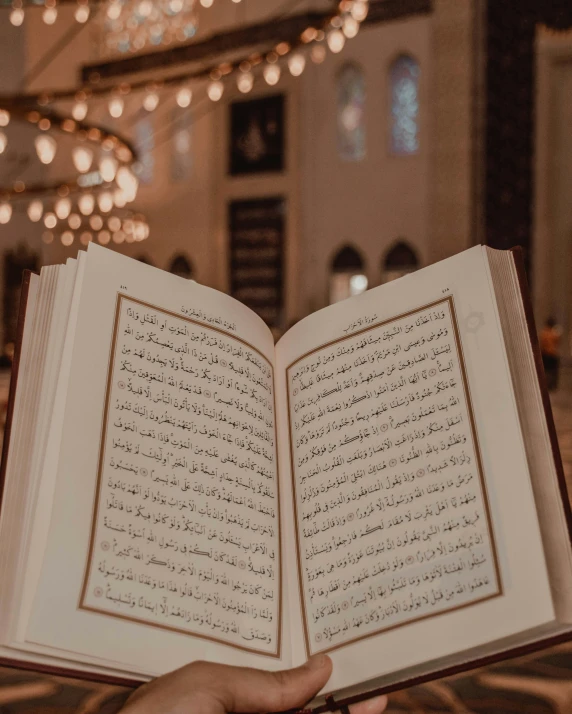 a person holding an open book in a church, trending on unsplash, hurufiyya, lit. 'honored ka'bah'), 2 0 0 0's photo, gif, multiple stories