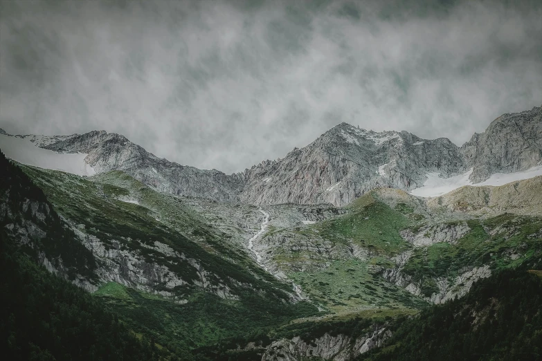 a mountain range with snow covered mountains in the background, by Adam Szentpétery, pexels contest winner, overcast gray skies, paul barson, large scale photo, lush scenery