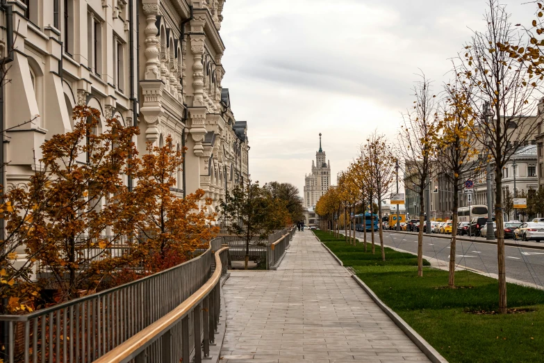 a city street lined with lots of tall buildings, by Serhii Vasylkivsky, unsplash contest winner, socialist realism, moscow kremlin, maple trees along street, empty buildings with vegetation, 000 — википедия