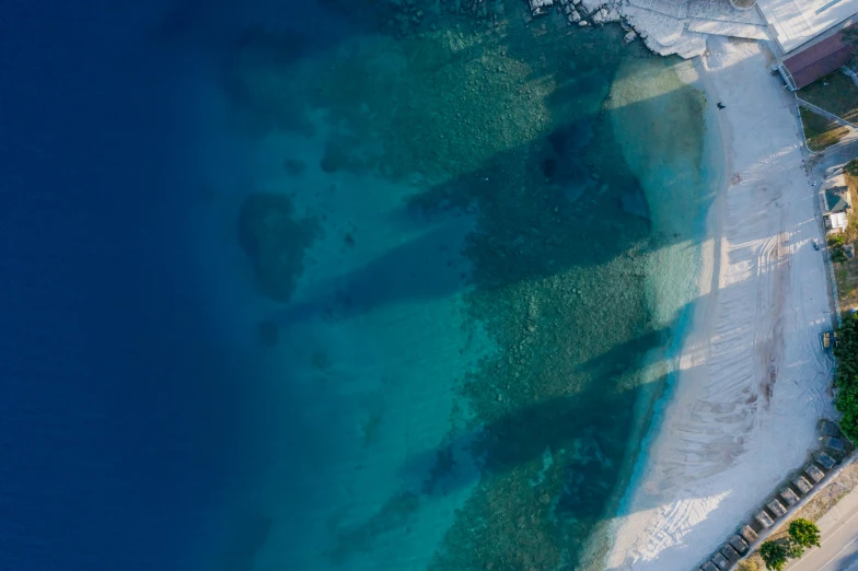 a large body of water next to a beach, by Julian Allen, pexels contest winner, hurufiyya, down there, half blue, depth detailed, cyprus