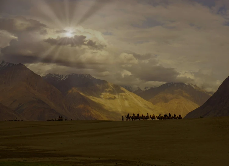 a group of people riding on the backs of horses, a detailed matte painting, inspired by Steve McCurry, pexels contest winner, land art, sun ray, background image, india