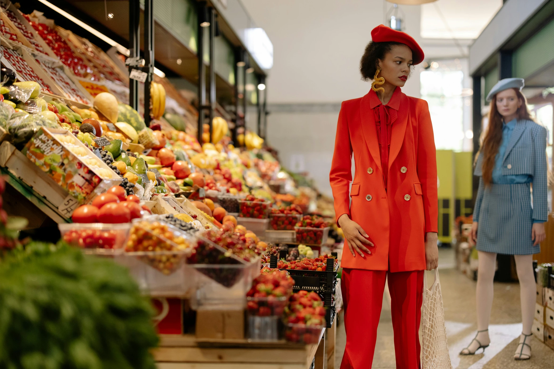 a woman in a red suit standing next to a woman in a blue dress, by Julia Pishtar, pexels, hyperrealism, fresh food market people, shopping groceries, white suit and hat, high fashion