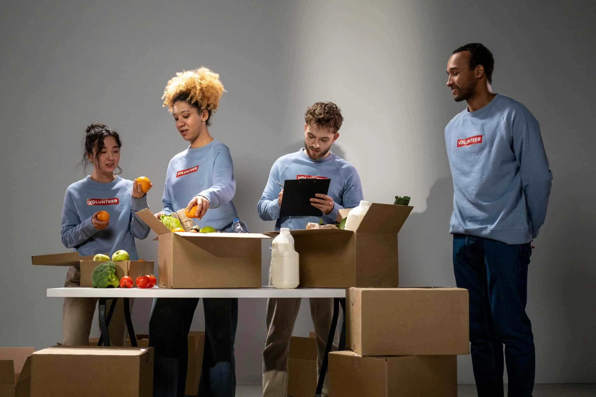 a group of people standing around a table with boxes, product shoot, getting groceries, avatar image, performance