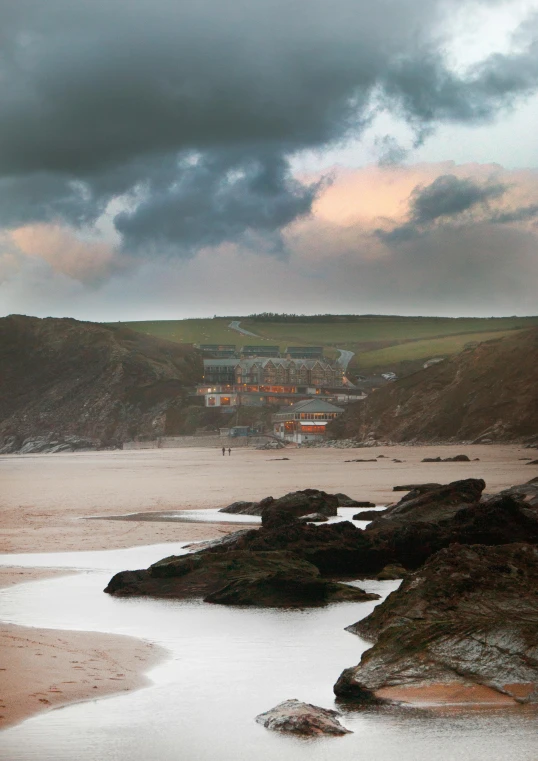 a large body of water sitting on top of a sandy beach, a portrait, medieval coastal village, rock pools, stormy setting, merlin