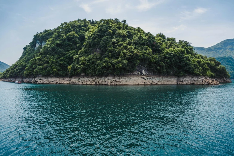 a small island in the middle of the ocean, inspired by Tadao Ando, pexels contest winner, sōsaku hanga, lush forests, seoul, conde nast traveler photo, croatian coastline