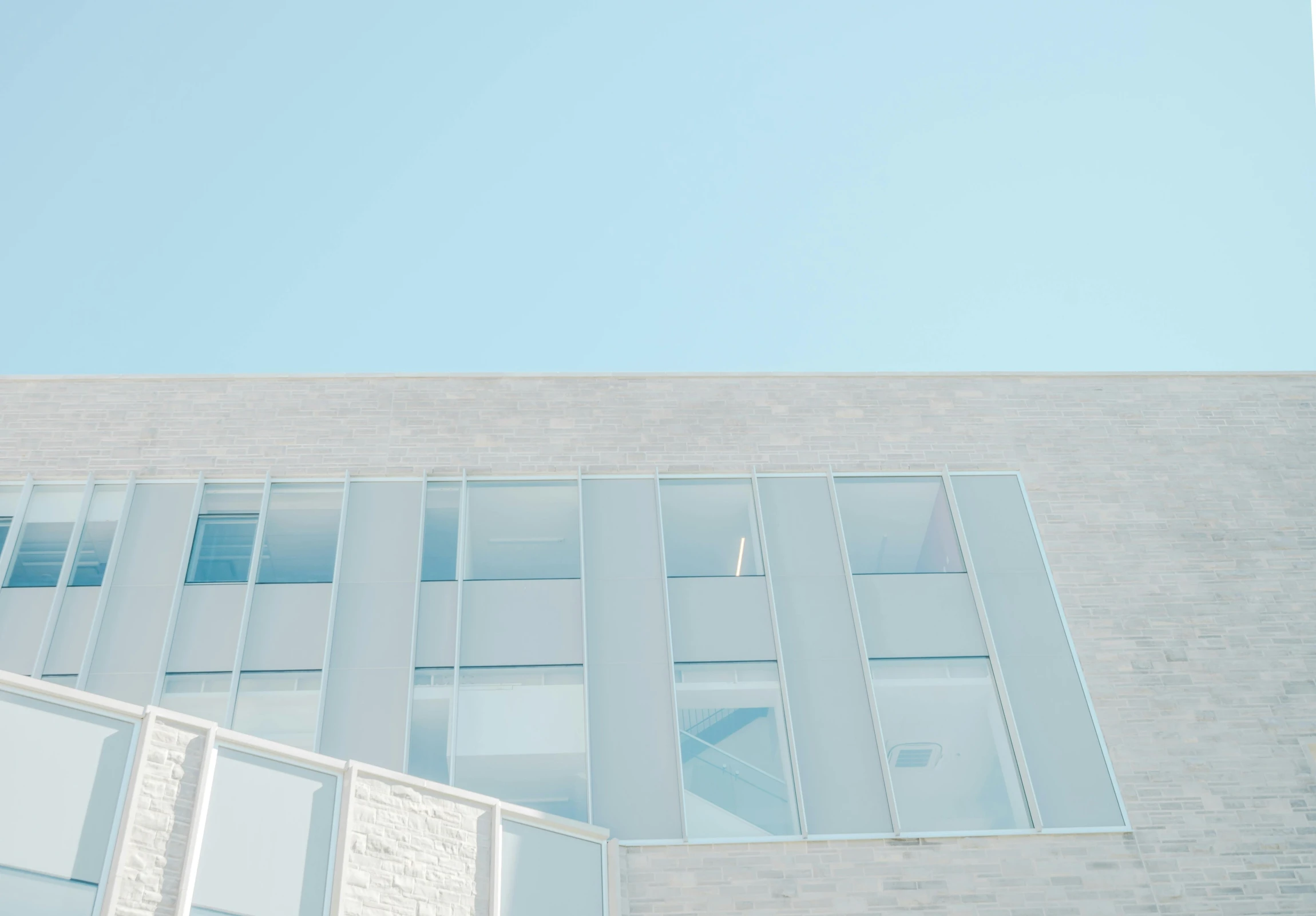 a man riding a skateboard up the side of a building, a minimalist painting, inspired by Richard Wilson, pexels contest winner, light and space, white and pale blue toned, glass panes, medical research facility, photo of a beautiful window