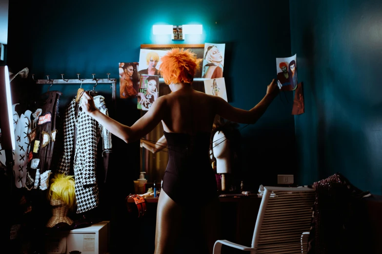 a woman standing in front of a mirror in a room, inspired by Nan Goldin, pexels contest winner, madison beer as leeloo, burlesque psychobilly, teal and orange colours, a magician's chamber