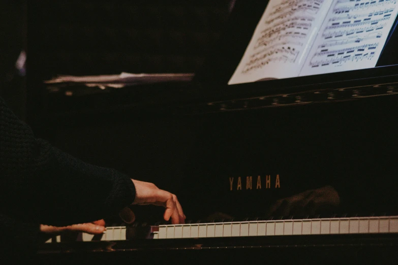 a close up of a person playing a piano, oyama kojima, colour corrected, brown, recital