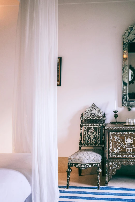 a bed room with a bed a chair and a mirror, inspired by Riad Beyrouti, trending on unsplash, baroque, silver filigree details, alizarin curtains, black white pastel pink, brown and white color scheme