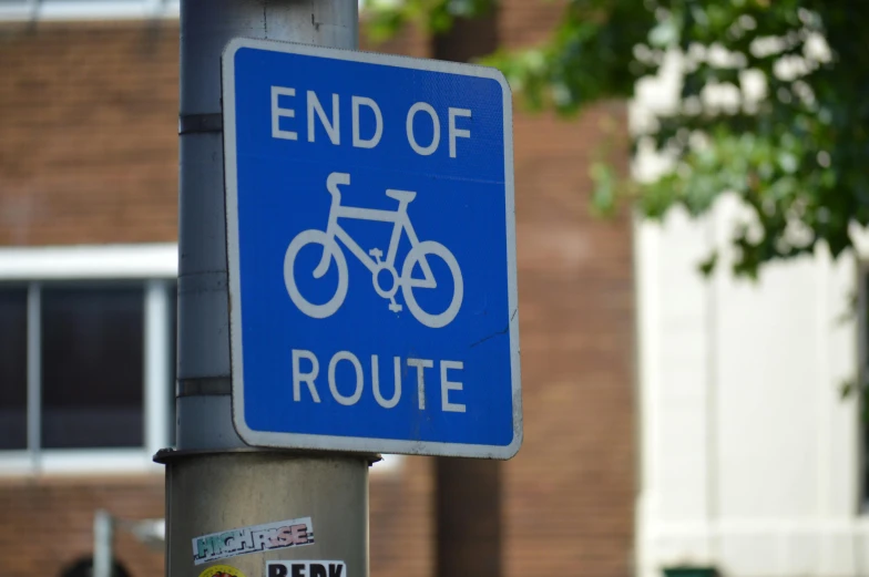 a close up of a street sign on a pole, riding a bike, blue print, endings, but resolute