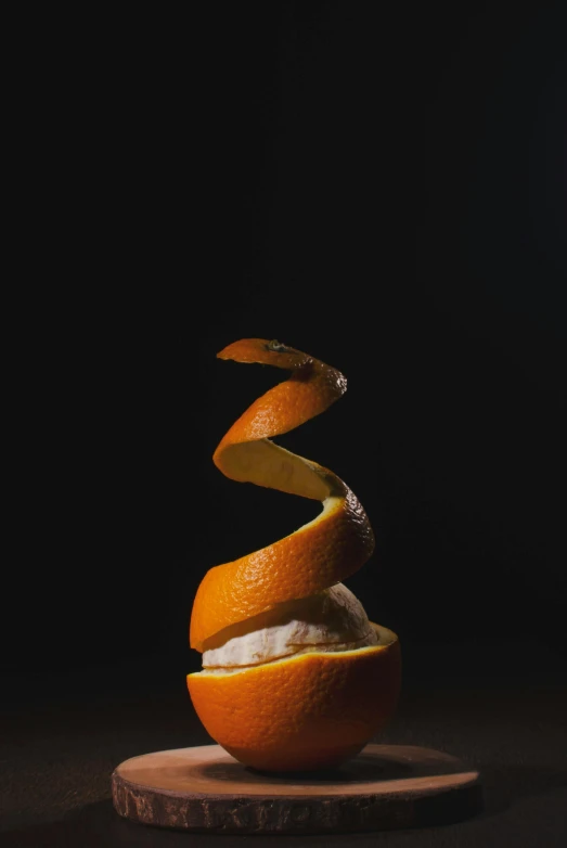 an orange sitting on top of a piece of wood, a still life, by Daniel Seghers, pexels, whipped cream on top, vine twist, whirling, profile picture