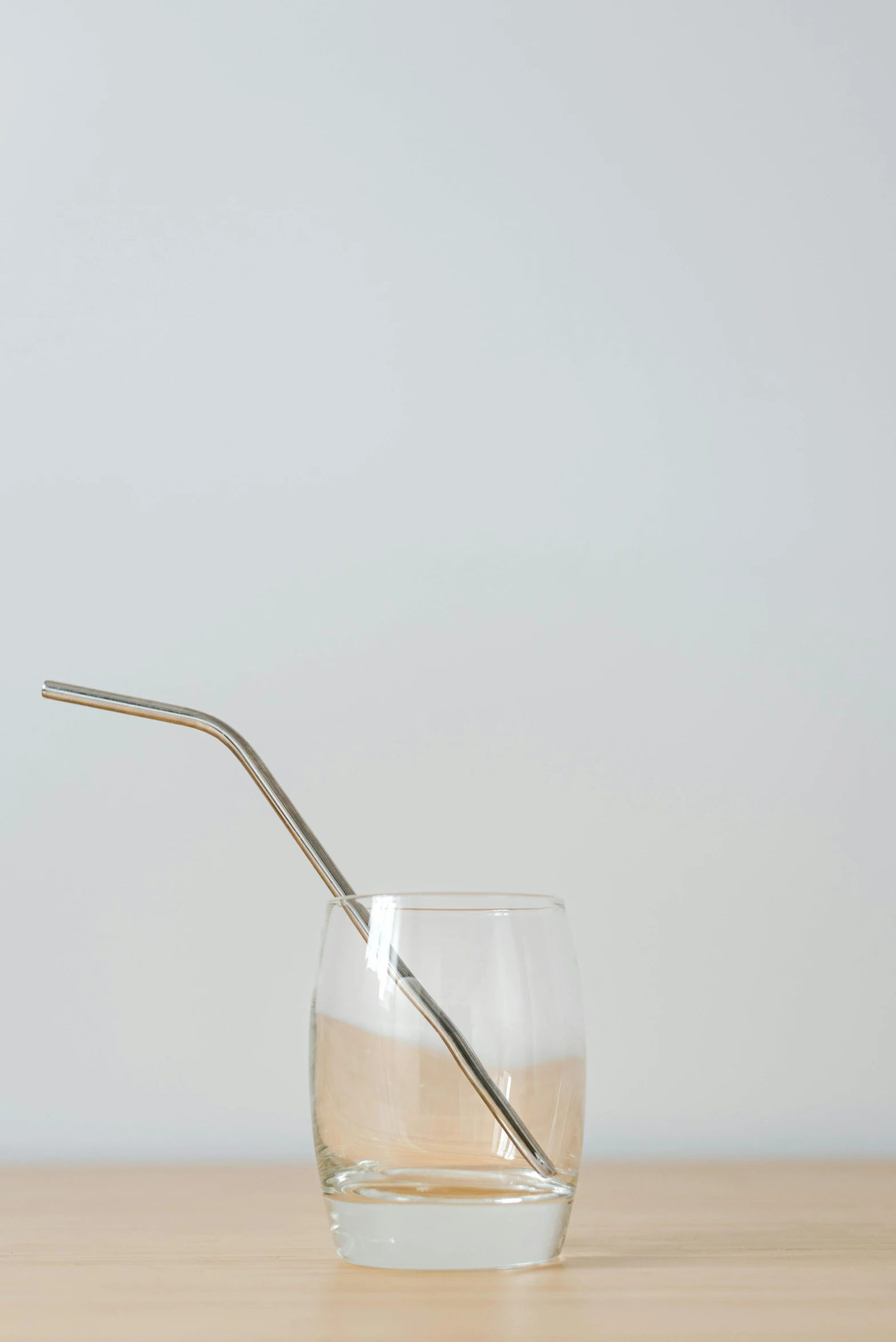 a glass of water with a straw sticking out of it, a picture, by Richmond Barthé, unsplash, minimalism, made of brushed steel, light tan, highly detailed product photo, long arm