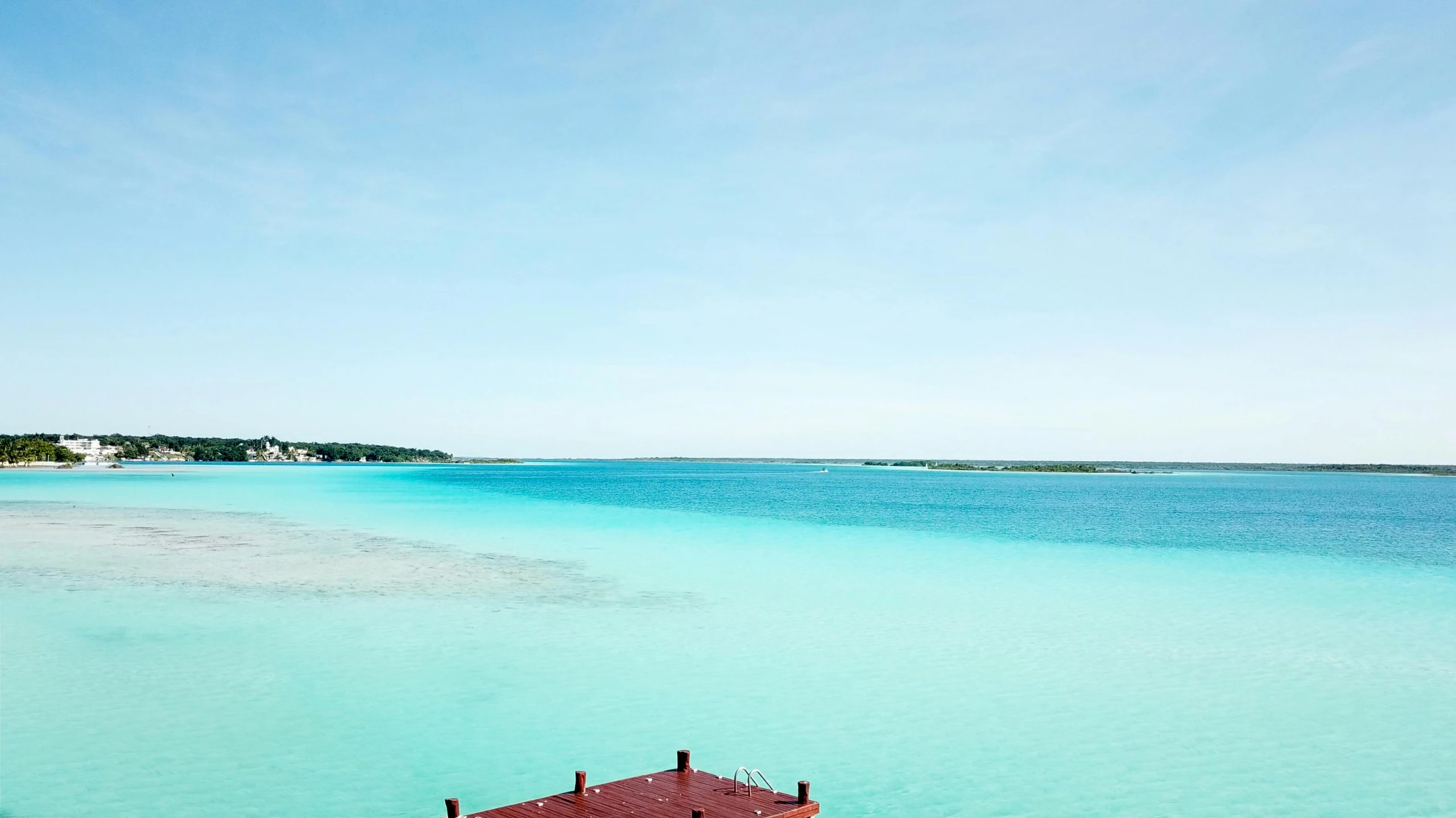 a dock in the middle of a large body of water, hurufiyya, turquoise water, varadero beach, turquoise and venetian red, lake in the distance