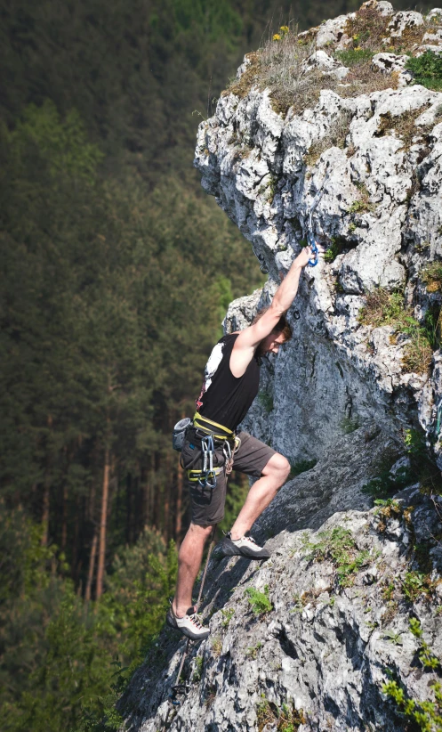 a man climbing up the side of a mountain, set photo