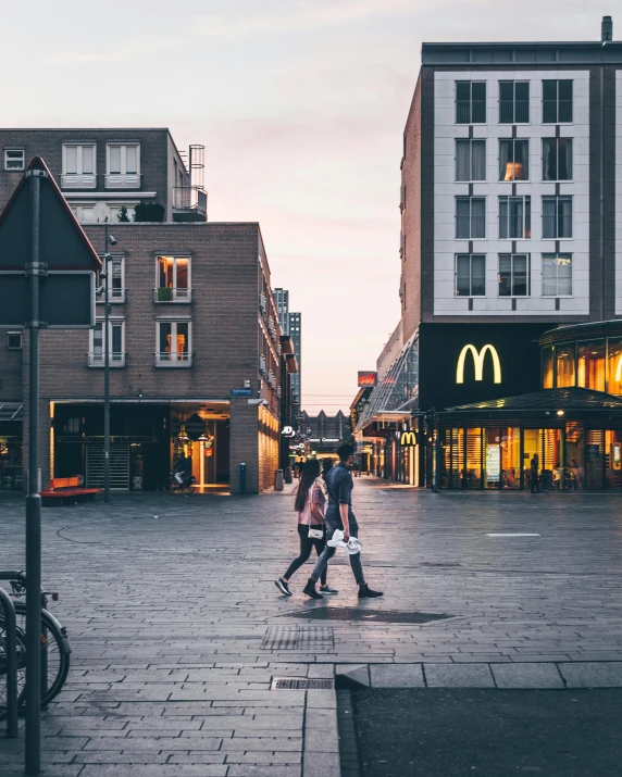 a couple of people that are walking down a street, by Micha Klein, pexels contest winner, modernism, working at mcdonalds, square, scandinavian