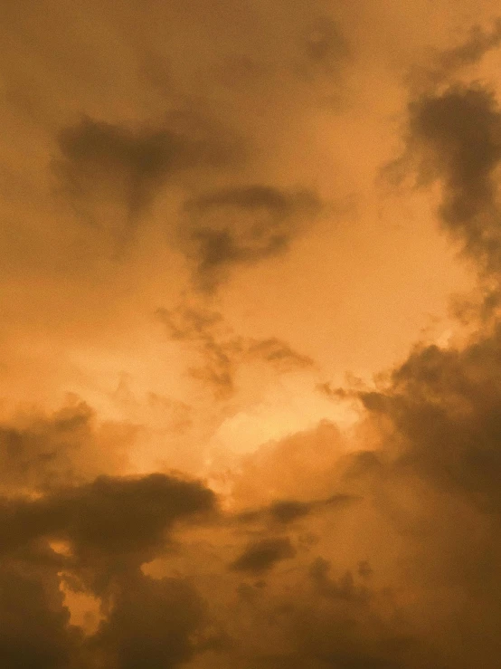 a large jetliner flying through a cloudy sky, an album cover, unsplash, romanticism, orange hue, ☁🌪🌙👩🏾, evening storm, a close-up