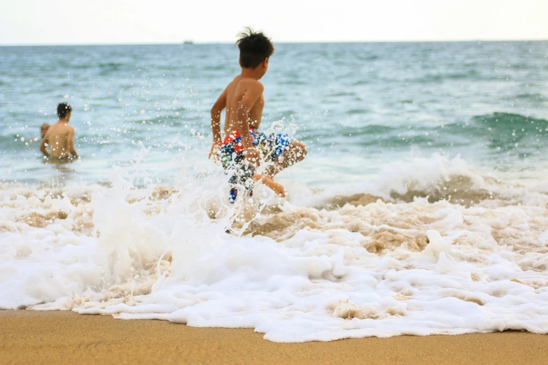 a young boy running into the ocean with a surfboard, pexels contest winner, happening, slip n slide, thumbnail, sea foam, thawan duchanee