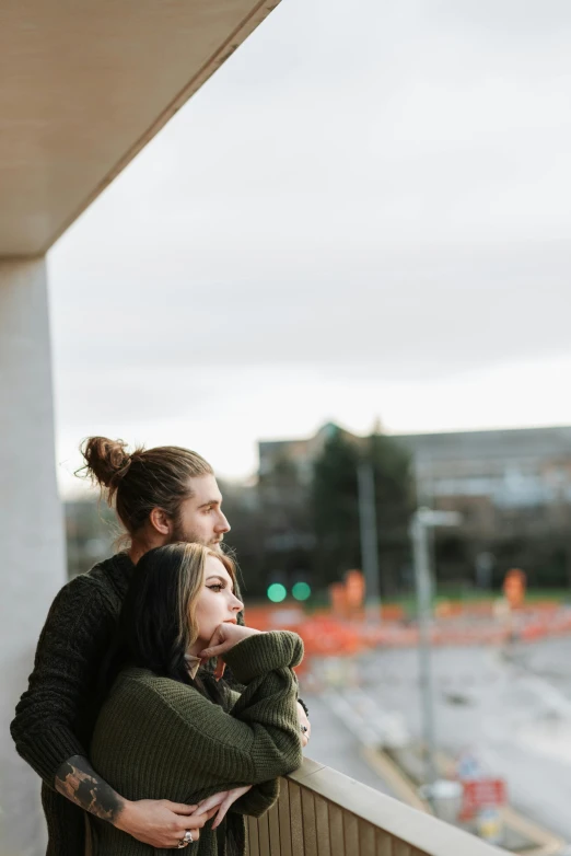 a man and a woman hugging on a balcony, a photo, trending on unsplash, college, rectangle, unfinished, high resolution image