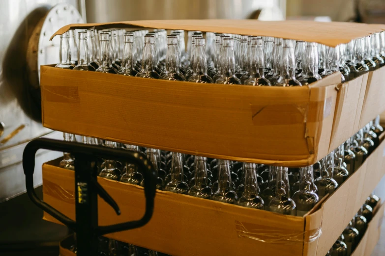 a stack of wine glasses sitting on top of a cart, process art, conveyor belts, packaging, brown, pack