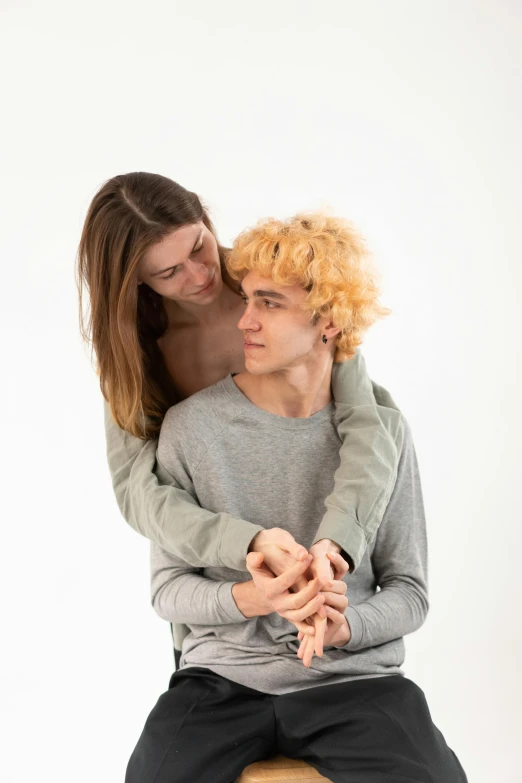 a man and a woman sitting on a stool, trending on unsplash, antipodeans, hugging each other, pale skin curly blond hair, teenage boy, wearing turtleneck