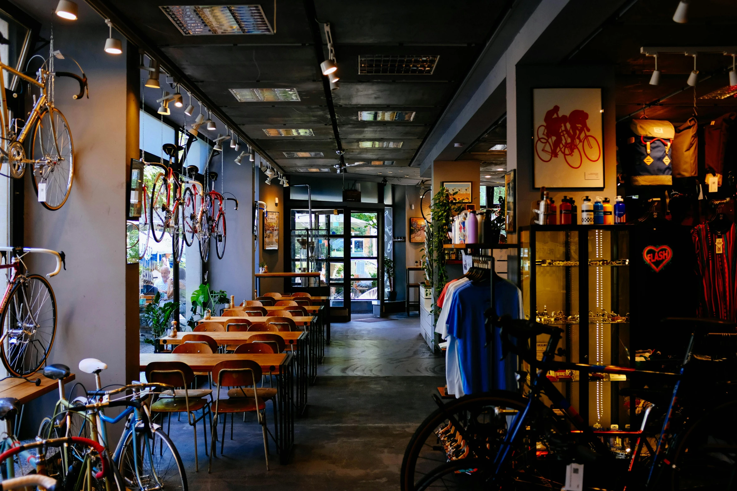 a room filled with lots of tables and bikes, a portrait, unsplash, arasaka, storefront, bo chen, lush surroundings