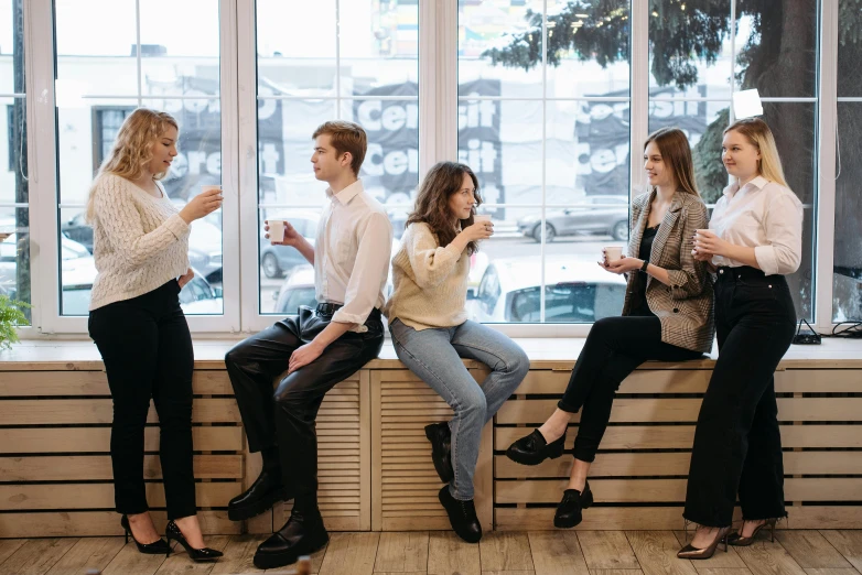 a group of people sitting on a window sill, trending on pexels, aussie baristas, sitting in a waiting room, flirting, yulia nevskaya