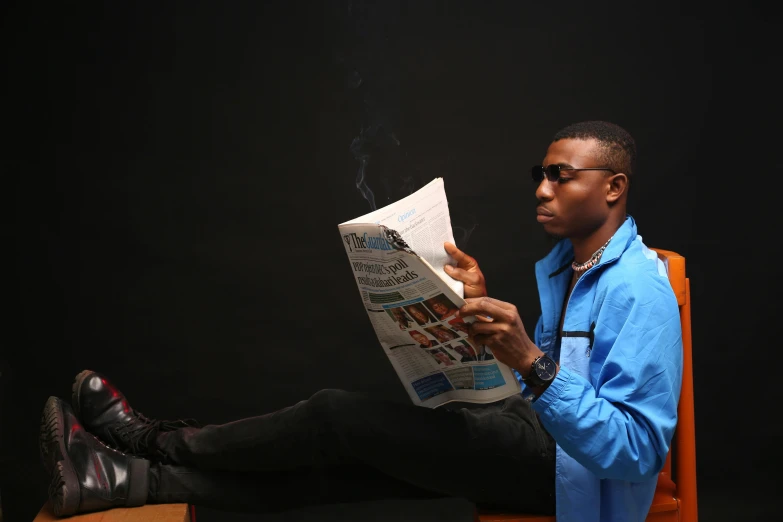 a man sitting on a chair reading a newspaper, an album cover, pexels contest winner, adebanji alade, wearing blue jacket, smoking a joint, student