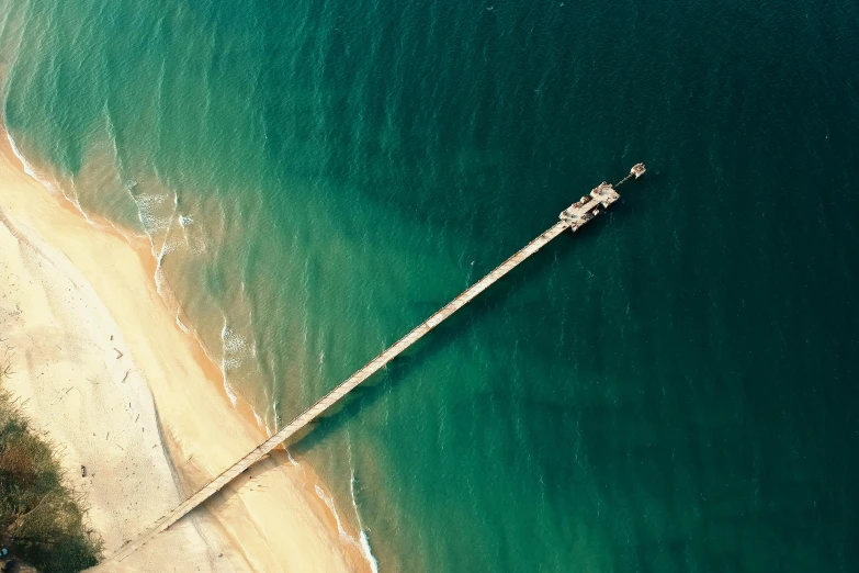 a pier in the middle of a body of water, pexels contest winner, satellite imagery, sandy green, 2 5 6 x 2 5 6 pixels, looking partly to the left