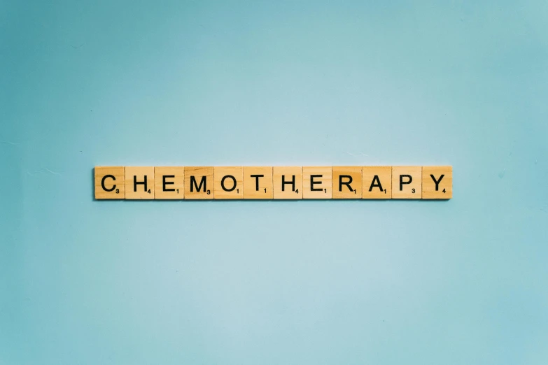 the word chemo therapy spelled in scrabbles on a blue background, colour corrected, of walter white, ecommerce photograph, honey