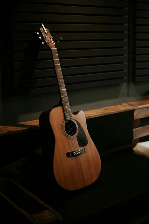 a guitar sitting on top of a wooden bench, studio room, multiple stories, maverick studio, premium