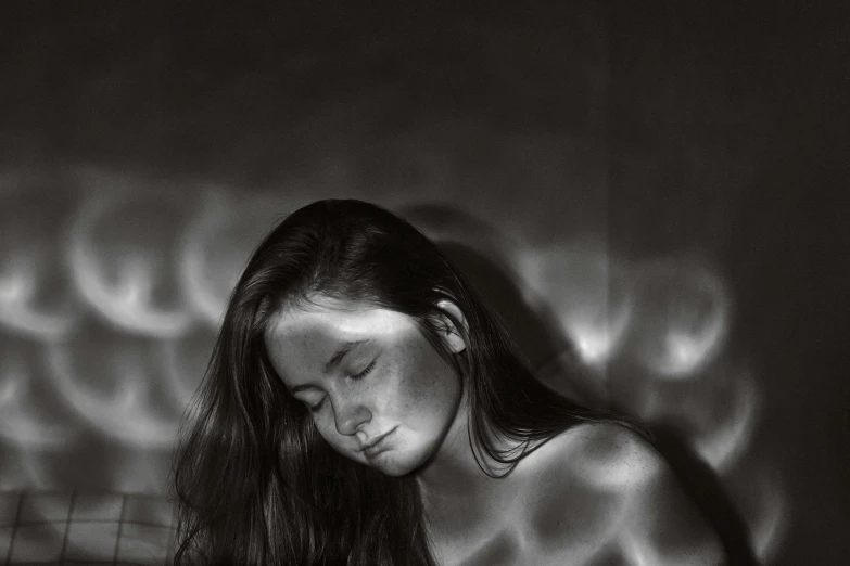 a black and white photo of a woman reading a book, inspired by Max Dupain, hyperrealism, skin made of led point lights, washing her dark long hair, sunburn, glowing