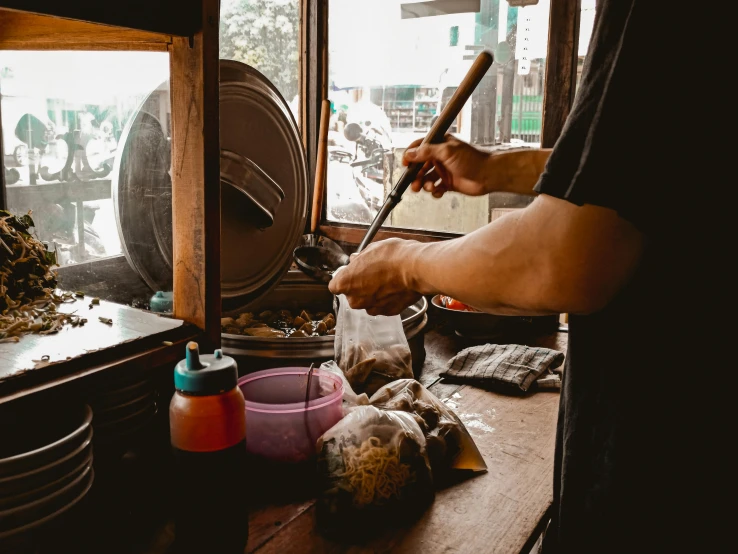 a man that is standing in front of a stove, a silk screen, pexels contest winner, bangkok, shop window for magical weapons, woodturning, avatar image