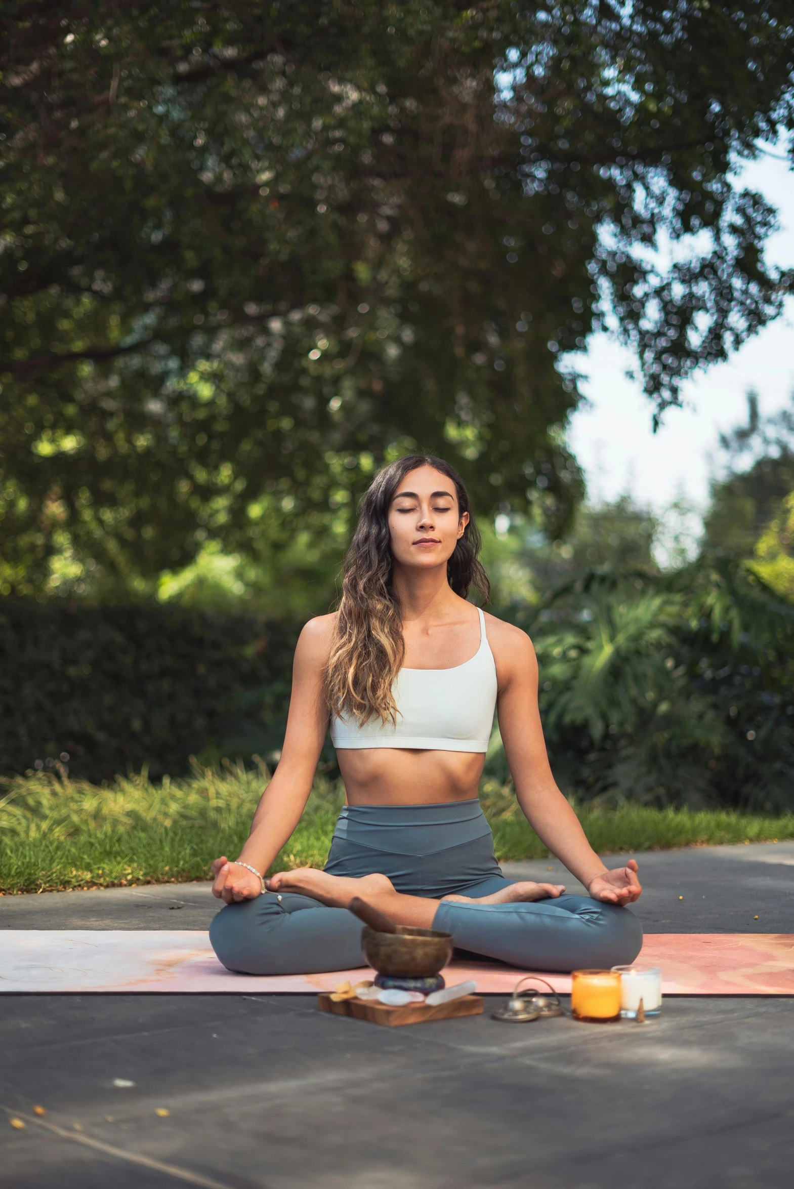 a woman sitting in the middle of a road doing yoga, a portrait, trending on pexels, lush surroundings, avatar image, hispanic, pastel'