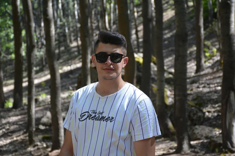 a man standing in the woods with a frisbee, a picture, inspired by Ion Andreescu, pexels contest winner, graffiti, wearing shades, headshot profile picture, you may say i'm a dreamer, wearing adidas clothing