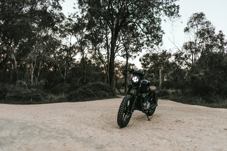 a motorcycle parked on the side of a dirt road, a portrait, unsplash contest winner, sydney park, flashing lights, classic gem, slim build