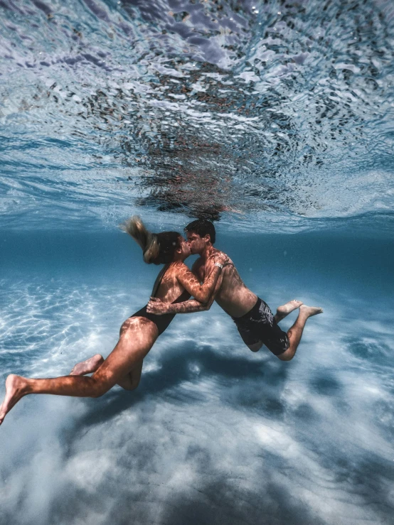 a man swimming in the ocean with a surfboard, a picture, unsplash contest winner, renaissance, couple kissing, bubbly underwater scenery, 4k), laying on sand