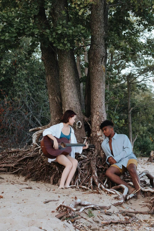 a man and a woman sitting next to a tree, an album cover, by Jessie Algie, unsplash, beaches, musician, r&b, vine