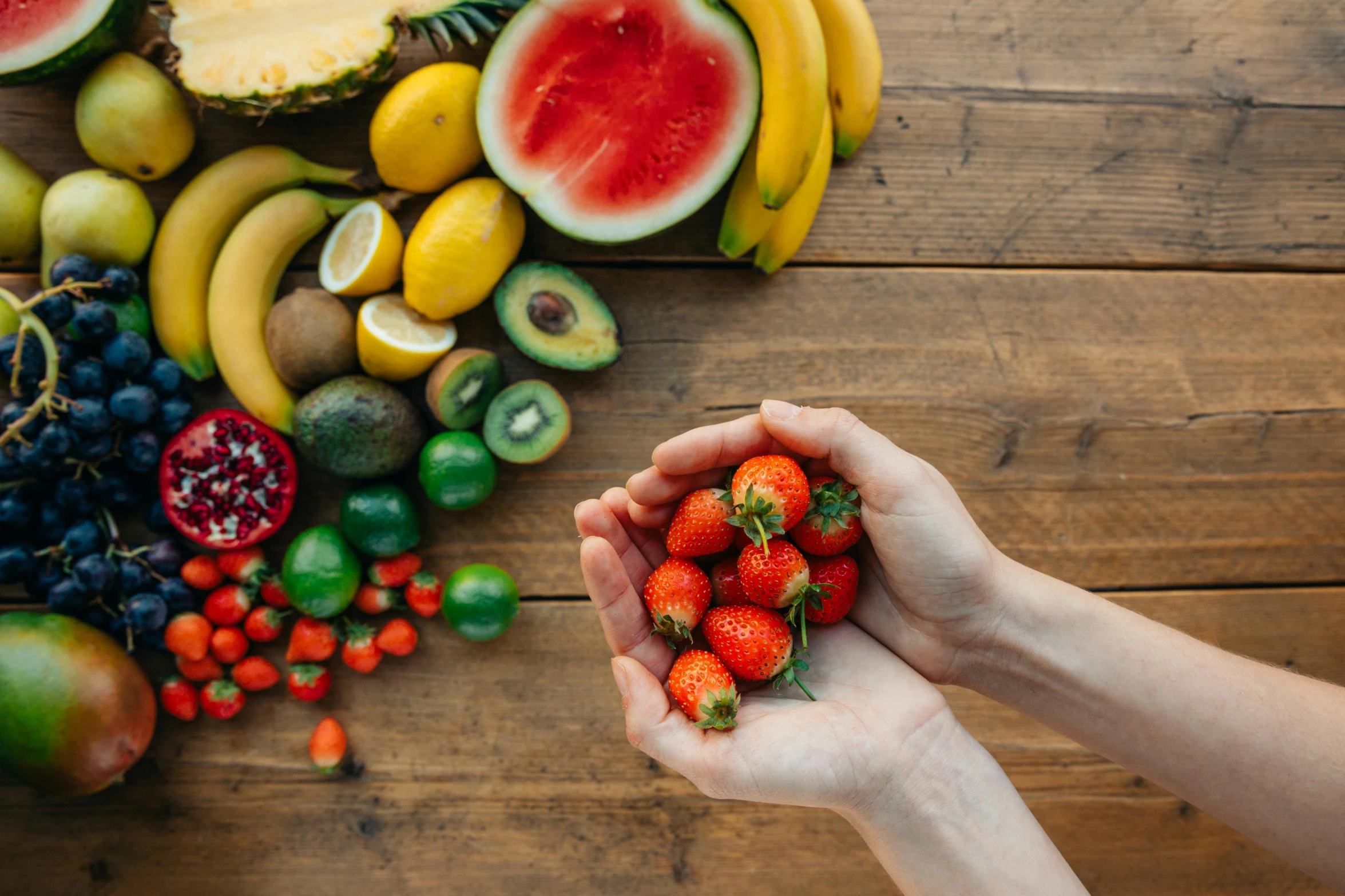 a person holding a bunch of fruit in their hands, pexels contest winner, ingredients on the table, avatar image, background image, uncropped