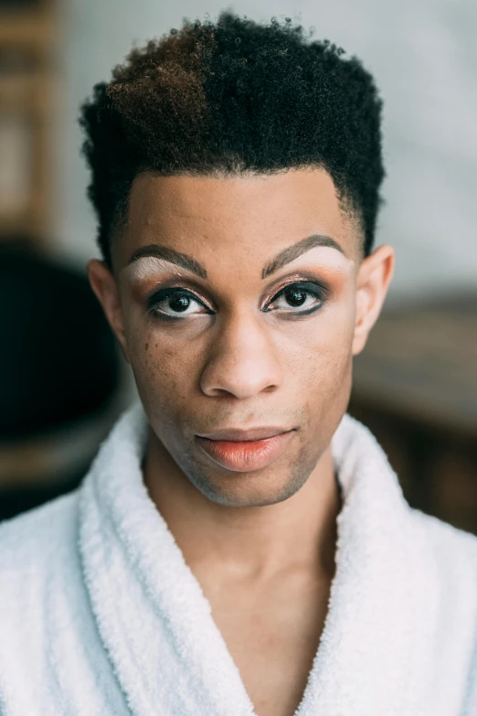 a close up of a person wearing a robe, by Cosmo Alexander, androgynous face, rodney matthew, groomed eyebrows, looking towards camera