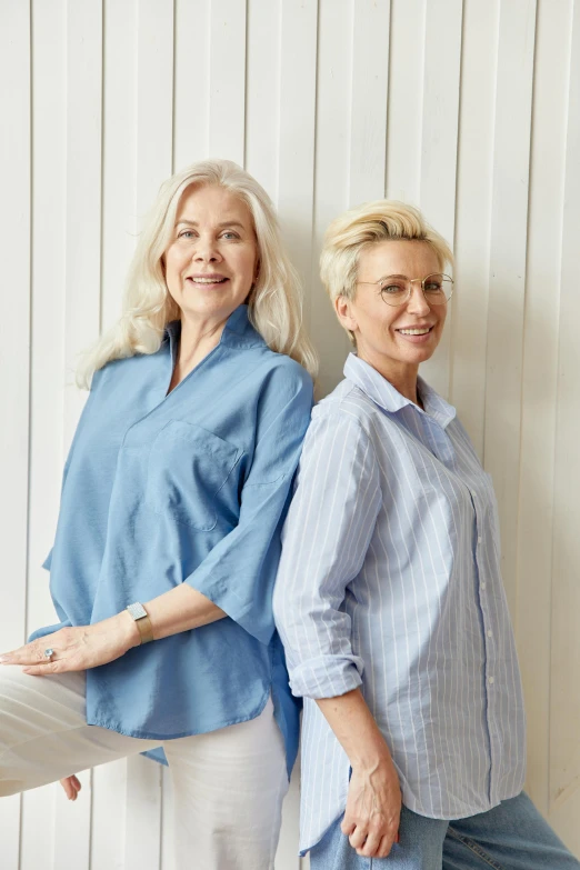 a couple of women standing next to each other, inspired by Irene and Laurette Patten, wearing a light blue shirt, scandinavian design, wearing silver hair, ultra - quality