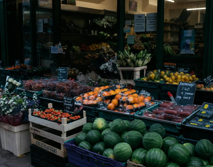 a fruit and vegetable stand in front of a store, by Niko Henrichon, pexels, square, seasonal, good lighting, a green