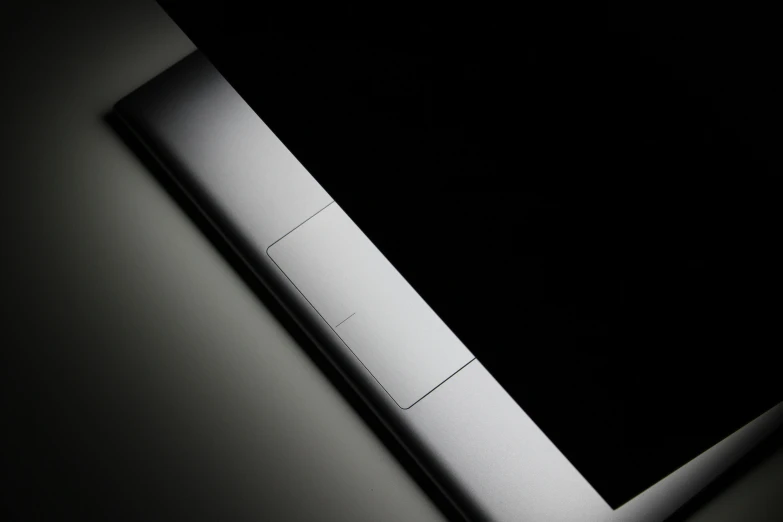 a laptop computer sitting on top of a table, by Adam Chmielowski, minimalism, skin detail, silver details, noir, rectangle