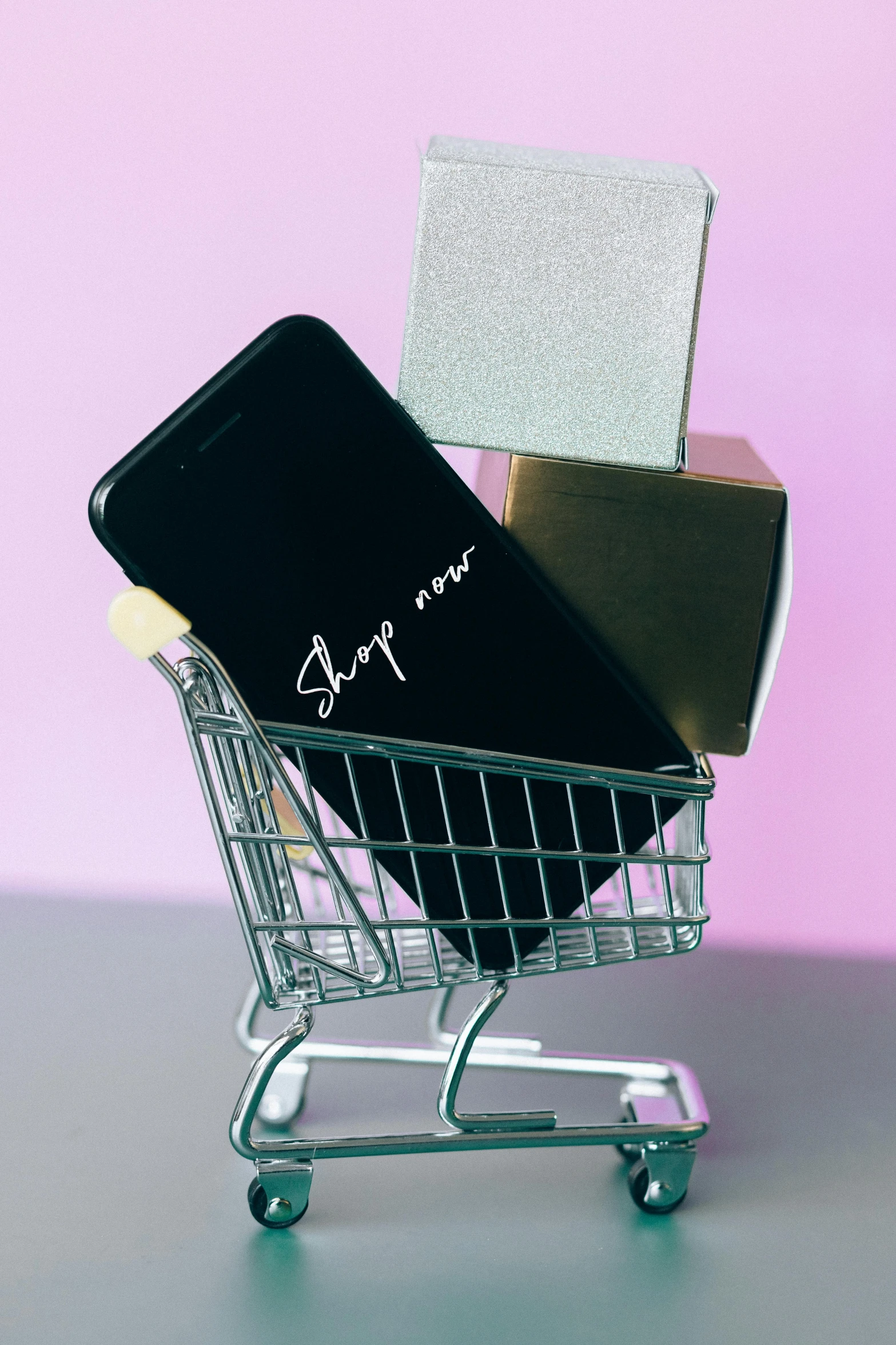 a mobile phone sitting in a shopping cart, by Julia Pishtar, slay, curated collections, black, hey