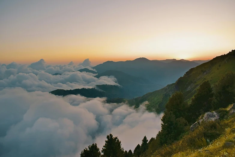 the sun is setting over the mountains above the clouds, pexels contest winner, overlooking a valley with trees, italy, extreme panoramic, conde nast traveler photo